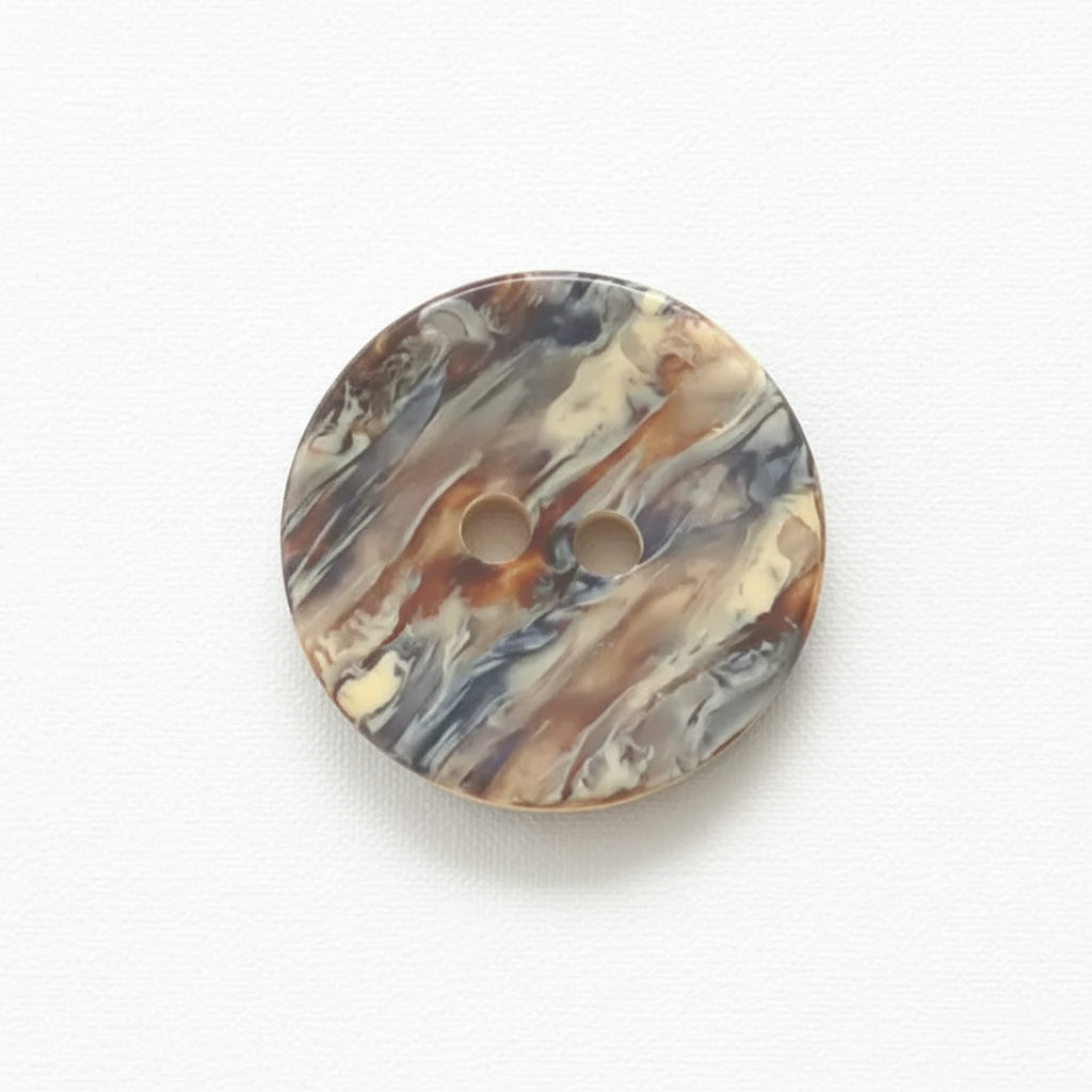 Marbled patterned button on a white background