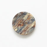 Marbled patterned button on a white background