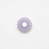 Decorative purple circular design on a white background