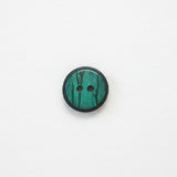 Green button with two holes on a white background