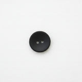 Black matte button with two holes on a white background