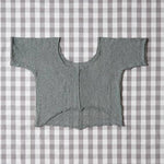 Gray knitted cardigan on a gray and white checkered background