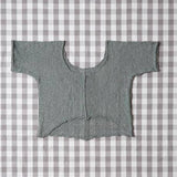 Gray knitted cardigan on a gray and white checkered background