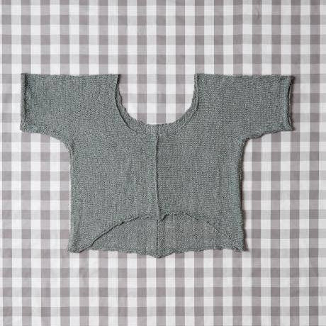 Gray knitted cardigan on a gray and white checkered background