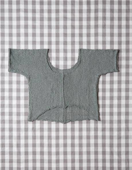 Gray knitted cardigan on a gray and white checkered background