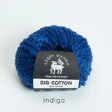 Blue skein of yarn with Loopy Mango label on a white background