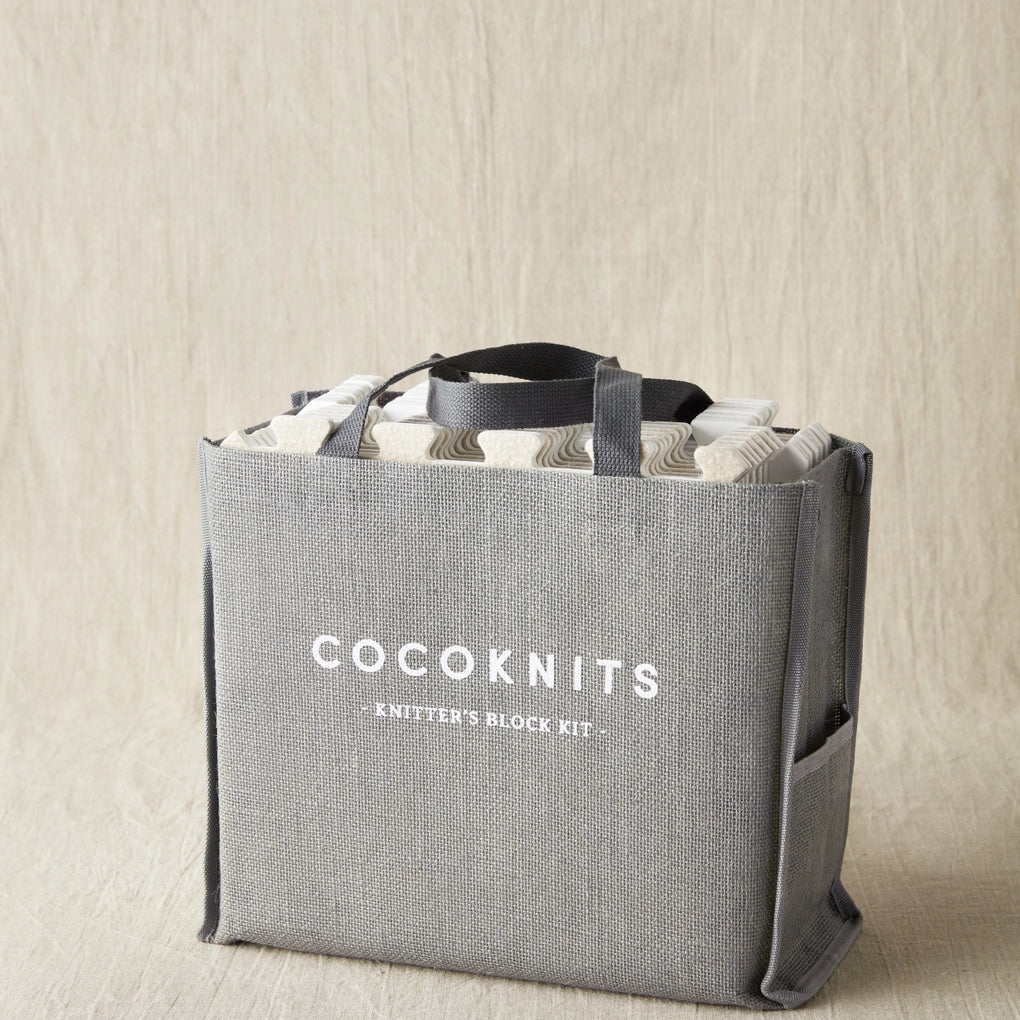 Gray tote bag with 'Cocoknits' branding on a beige background