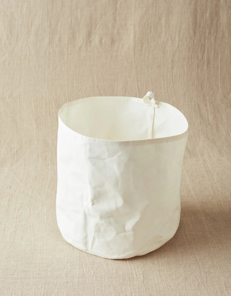 White fabric bin on a beige background