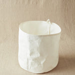 White fabric bin on a beige background
