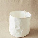 White fabric bin on a beige background