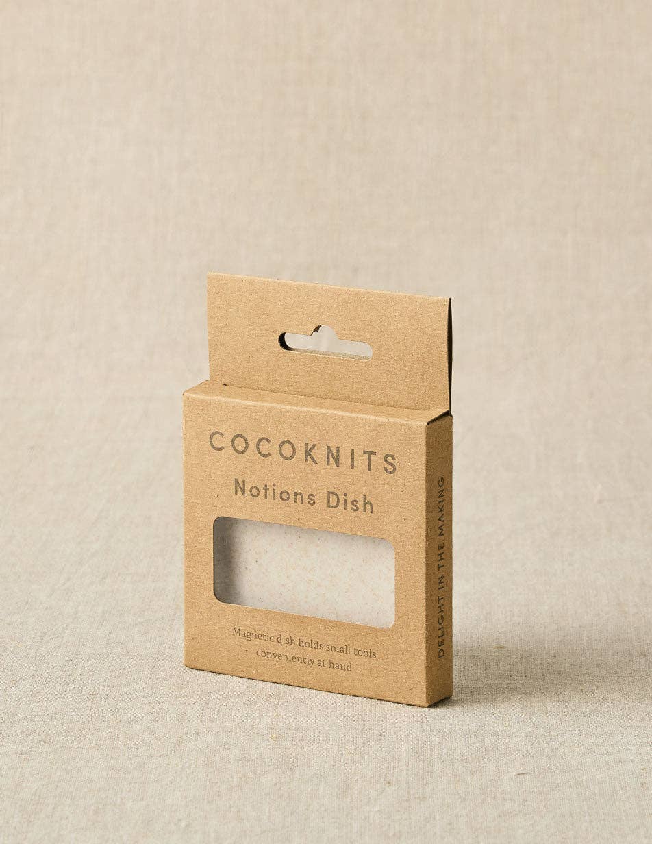 Cocoknits notions dish packaging on a beige background