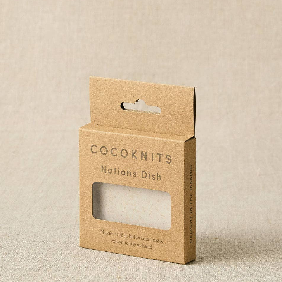 Cocoknits notions dish packaging on a beige background