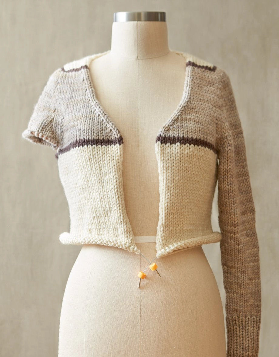 Knitted cardigan on a mannequin against a neutral background