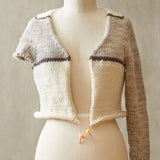 Knitted cardigan on a mannequin against a neutral background