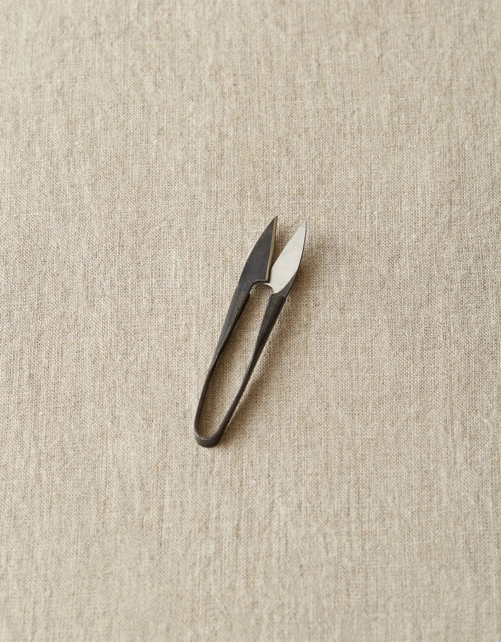 Yarn Snips on a beige textured background