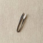 Yarn Snips on a beige textured background