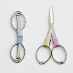 Pair of scissors with colorful handles on a white background