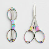 Pair of scissors with colorful handles on a white background