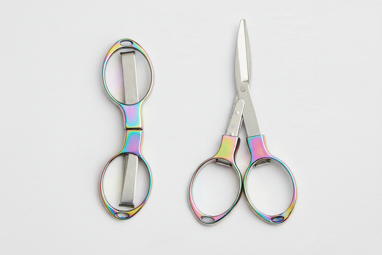 Pair of scissors with colorful handles on a white background