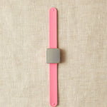 Pink slap bracelet with a square magnet.