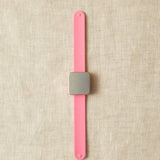 Pink slap bracelet with a square magnet.